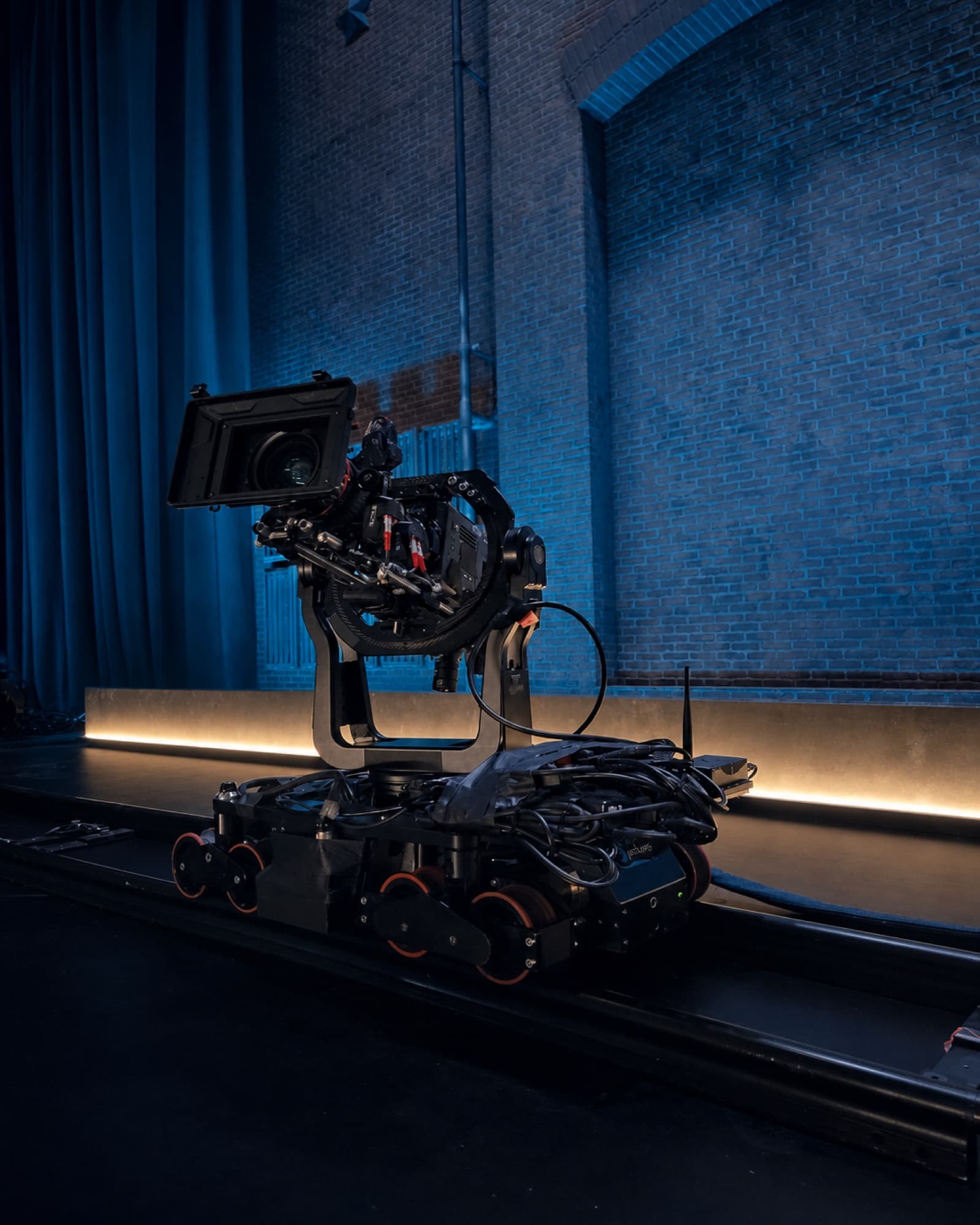 Fluid Pictures robotic rail camera dolly carrying a cinema camera on precision track
